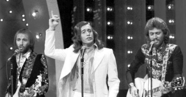 Image in QuizMyDay 70s Chart Toppers Trivia Quiz: No. 1 Hits by Year trivia quiz featuring Photo of the Bee Gees performing on the television program <i>The Midnight Special</i>.