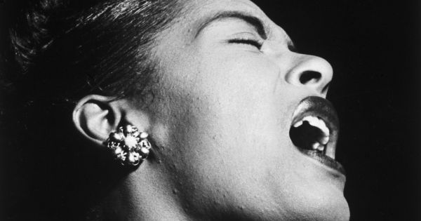Image in QuizMyDay Billie Holiday Harmony Quiz: Test Your Jazz Genius trivia quiz featuring <a href="//commons.wikimedia.org/wiki/Billie_Holiday" title="Billie Holiday">Billie Holiday</a> at the <a href="https://en.wikipedia.org/wiki/List_of_jazz_venues_in_the_United_States#New_York" class="extiw" title="w:List of jazz venues in the United States">Downbeat</a> club, a <a href="https://en.wikipedia.org/wiki/jazz_club" class="extiw" title="w:jazz club">jazz club</a> in <a href="//commons.wikimedia.org/wiki/New_York_City" title="New York City">New York City</a>. <a rel="nofollow" class="external autonumber" href="https://www.theguardian.com/books/2015/may/03/billie-holiday-musician-myth-review-john-szwed-celebration-true-original">[1]</a>