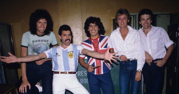 Image for Quiz free quiz game featuring English rock band Queen (with Freddy Mercury in an Argentina jersey) meeting Diego Maradona (wearing an Union Flag jersey) before their last concert in Argentina during the The Game Tour