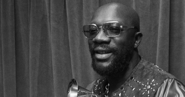 Image in QuizMyDay Shaft Your Knowledge: The Ultimate Isaac Hayes Quiz trivia quiz featuring Isaac Hayes holding his Grammy award for Shaft in 1972. Photo itself marked 1973