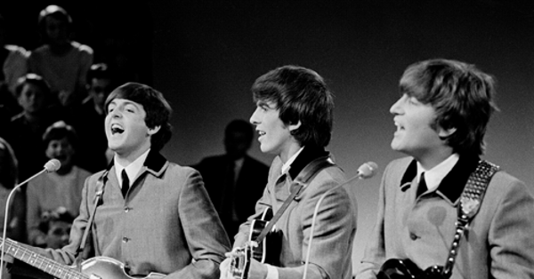 Three Beatles members Paul McCartney, George Harrison, and John Lennon performing for Dutch television.
