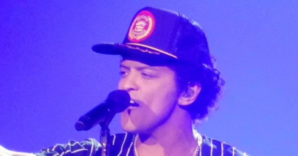 Image in QuizMyDay How Well Do You Know Bruno Mars' Personal Life? Take the Quiz! trivia quiz featuring This is a photo of American entertainer Bruno Mars performing live during his 24K Magic World Tour