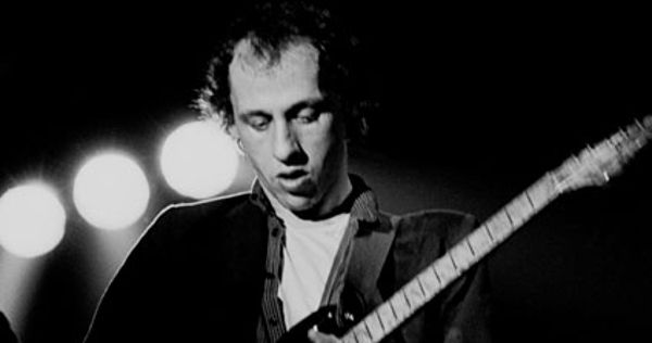 Image in QuizMyDay Dire Straits 'Brothers in Arms' Knowledge Quiz trivia quiz featuring Mark Knopfler, lead guitarist performing with Dire Straits Photographer: Eddie Mallin
