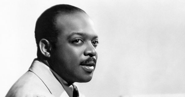 Image in QuizMyDay Count Basie Quiz: Swingin’ Jazz Mastery Trivia trivia quiz featuring Posed photo portrait of American jazz bandleader and pianist <a href="https://en.wikipedia.org/wiki/Count_Basie" class="extiw" title="w:Count Basie">Count Basie</a>, seated at the piano