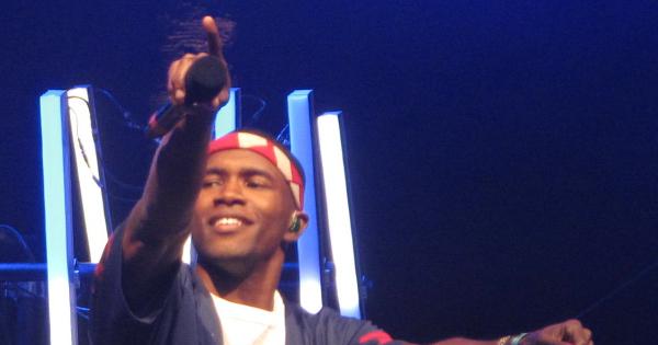 Image in QuizMyDay Thinkin Bout Trivia – How Well Do You Know Frank Ocean Songs? trivia quiz featuring Frank Ocean holds out his microphone to the crowd while performing at Coachella 2012.