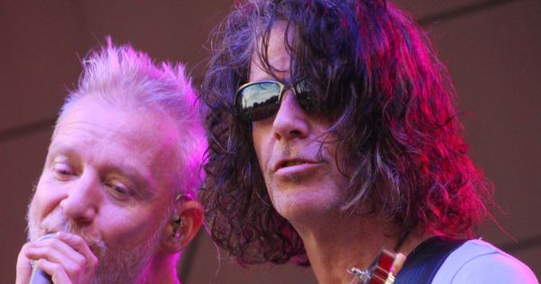 Image in QuizMyDay Spin Doctors Trivia: Ultimate Band Knowledge Quiz trivia quiz featuring Chris Barron singing and Eric Schenkman playing guitar at an outdoor concert by the Spin Doctors at the Mayo Civic Center in Rochester, Minnesota, United States