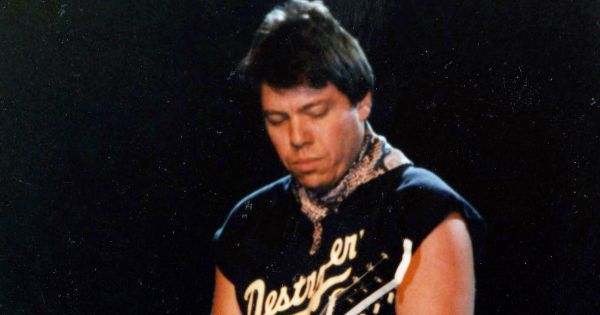 Image in QuizMyDay George Thorogood Quiz: Test Your Rock and Blues Facts trivia quiz featuring George Thorogood performs at William Paterson College (now University) on April 23, 1986.