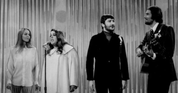 Image in QuizMyDay The Mamas & The Papas Quiz — 60s Hits & History trivia quiz featuring The Mamas and the Papas performing on The Ed Sullivan Show. From left-Michelle Phillips, Cass Elliot, Denny Doherty, and John Phillips.