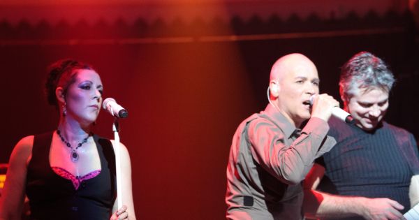 Image in QuizMyDay Ultimate Human League Knowledge Challenge Quiz trivia quiz featuring The Human League on stage at Paradiso, Amsterdam, Netherlands - from left to right Joanne Catherall, Phil Oakey, and Neil Sutton.
