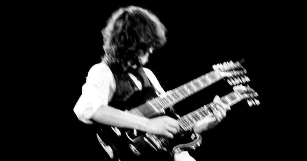 Image in QuizMyDay Led Zeppelin Trivia: 10-Question Quiz Challenge trivia quiz featuring Jimmy Page at the A.R.M.S. benefit at The Cow Palace, San Francisco, Ca., in 1983.