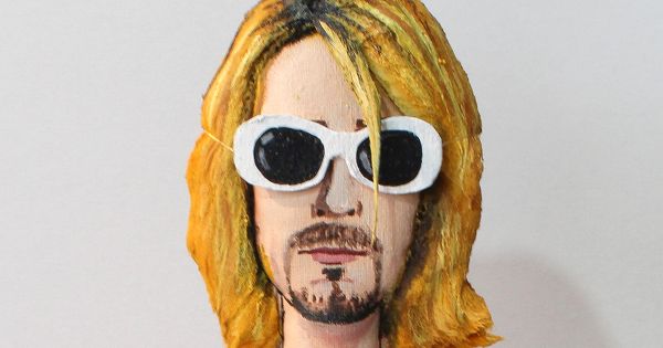 Image in QuizMyDay Nirvana Music Video Trivia — Guess the Iconic Videos trivia quiz featuring a Kurt Cobain doll