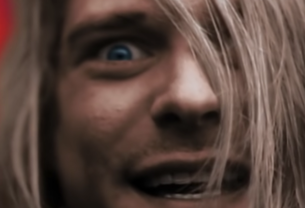 Image of Kurt Cobain looking straight at the camera an one of Nirvana's clips