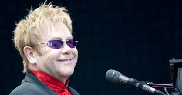 Image in QuizMyDay Elton John Album Quiz: How Well Do You Know His Records trivia quiz featuring <a href="https://en.wikipedia.org/wiki/Elton_John" class="extiw" title="w:Elton John">Elton John</a>, English singer-songwriter and pianist, performing on stage at the <a href="https://en.wikipedia.org/wiki/Keepmoat_Stadium" class="extiw" title="w:Keepmoat Stadium">Keepmoat Stadium</a>, Doncaster, England.
