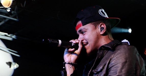 It is a photo of J.Cole performing in London, 2011.