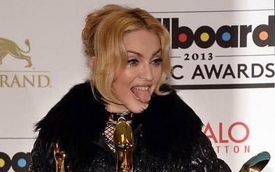 Photo caption: Post ceremony, Madonna shows off her awards. Madonna won for top touring artist, top dance artist, and top dance album. Photograph by Karen Blue, <b>available under a <a rel="nofollow" class="external text" href="https://creativecommons.org/licenses/by-sa/3.0/">Creative Commons Attribution and Share Alike license</a></b>. Copyright © 2013 Karen Blue.