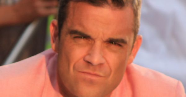 Image in QuizMyDay Robbie Williams Trivia Quiz: How Well Do You Know the Pop Icon? trivia quiz featuring Robbie Williams filming his music video at Old Spitalfields Market, (August 2012).