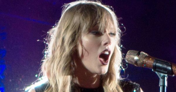 Image in QuizMyDay Taylor Swift Reputation Era Quiz: Test Your Album Facts trivia quiz featuring Swift performing on her Reputation Stadium Tour in May 2018