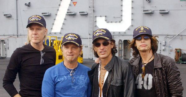 Image in QuizMyDay Aerosmith in the ’80s: Ultimate Knowledge Quiz trivia quiz featuring Norfolk, Va., aboard USS Harry S. Truman (CVN 75) Oct. 9, 2002 -- Internationally renowned rock band "Aerosmith" (from left:  Tom Hamilton, Joey Kramer, Joe Perry, and Steven Tyler) visited with Truman Sailors and toured the aircraft carrier pier side at Norfolk Naval Station.  The band had returned to perform in the area, having cancelled their original performance scheduled for September 11, 2001.  U.S. Navy photo by Photographer's Mate 3rd Class Christopher B. Stoltz.  (RELEASED)