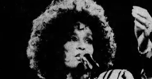 Image in QuizMyDay Whitney Houston Career Trivia Quiz trivia quiz featuring Whitney Houston performs in concert at the Garden State Arts Center in Holmdel (now PNC) on Aug.19, 1987, as part of her Moment of Truth world tour, supporting the "Whitney" album. (Noah K. Murray/The Star-Ledger). Newspaper clipping taken from The Star-Ledger, August 21, 1987.