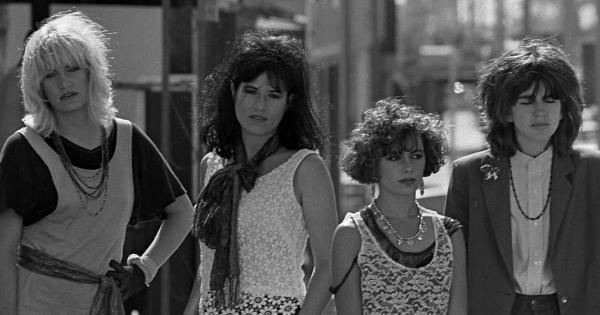 Image in QuizMyDay Ultimate Bangles Knowledge Quiz: Test Your Fanship trivia quiz featuring Los Angeles based music group, The Bangles, posing on street in Los Angeles. From left, Debbi Peterson, Vicki Peterson, Susanna Hoffs and Michael Steele