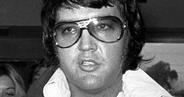 Image in QuizMyDay Test Your Elvis Quotes Knowledge: Ultimate Quiz trivia quiz featuring Elvis Presley leaving a courtroom in Santa Monica, California, after his divorce with Priscilla was finalized