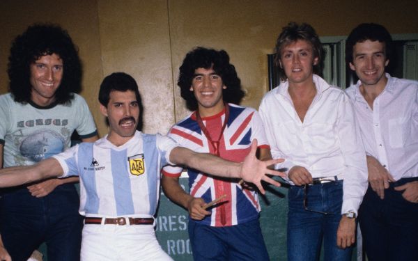 English rock band Queen (with Freddy Mercury in an Argentina jersey) meeting Diego Maradona (wearing an Union Flag jersey) before their last concert in Argentina during the <i>The Game Tour</i>.