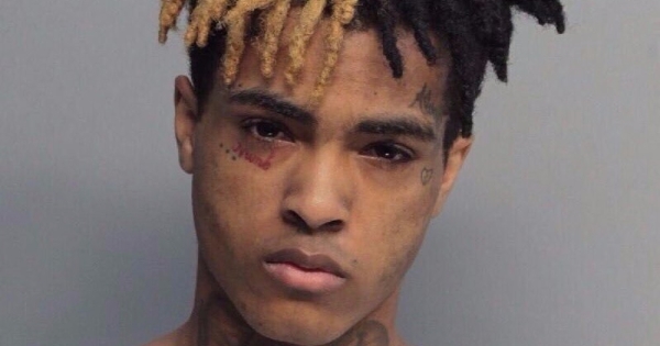 Image in QuizMyDay XXXTentacion Deep-Fact Quiz: Test Your Knowledge trivia quiz featuring Cover art of the Empire release of the single "Look at Me!" by XXXTentacion, his mugshot