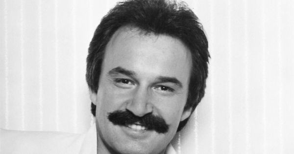 Image in QuizMyDay Disco Dreams and Synth Scenes: The Giorgio Moroder Quiz trivia quiz featuring Italian music producer Giorgio Moroder in 1979, in a publicity photo by Casablanca Records promoting his album <i>E=MC²</i>.