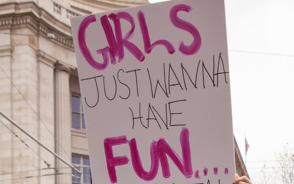 A San Francisco Women's March participant holds a sign reading "Girls Just Wanna Have Fun...damental Rights".