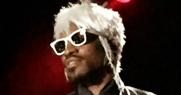 Image in QuizMyDay OutKast Deep-Dive: Ultimate Knowledge Quiz 2025 trivia quiz featuring Andre 3000 performing at the Best Buy Theater in Times Square New York for the Advertising Week party.