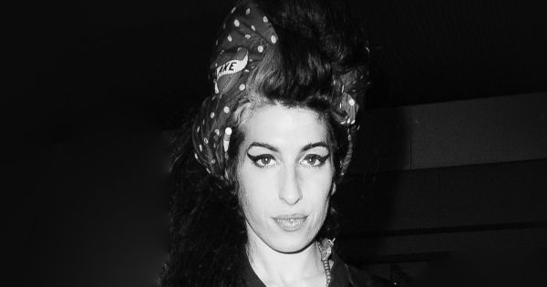 Image in QuizMyDay Amy Winehouse Quiz: Test Your Music Mastery Now trivia quiz featuring Amy Winehouse out walking near her house in Camden Town, London.