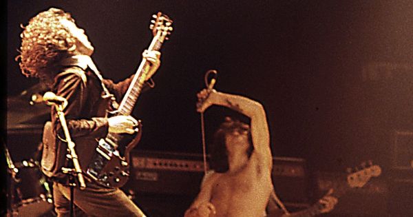 Image in QuizMyDay Identify the Hard Rock Band by Song Quiz: 10 Song Clues trivia quiz featuring <b><a href="//commons.wikimedia.org/wiki/AC/DC" title="AC/DC">AC/DC</a></b> at the Ulster Hall, Belfast. Angus Young (left) and Bon Scott (right).