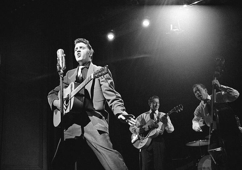 A Black and White picture of Elvis Presley live with Scotty Moore and Bill Black. This is the header picture for the oldies music QuizMyDay category